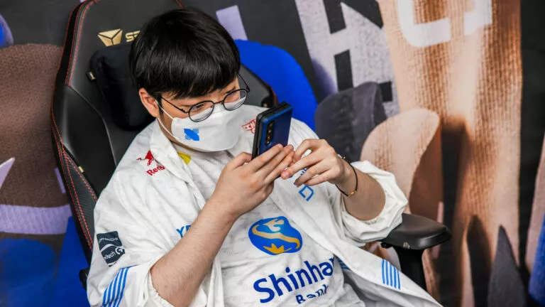 DRX player BeryL checks his phone backstage during the Worlds 2022 final.