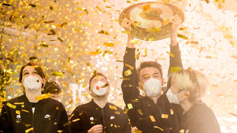 an image of Team Spirit lifting the Aegis after winning The International 2021